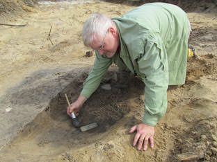 Excavating a feature at Mitchelville in 2013.